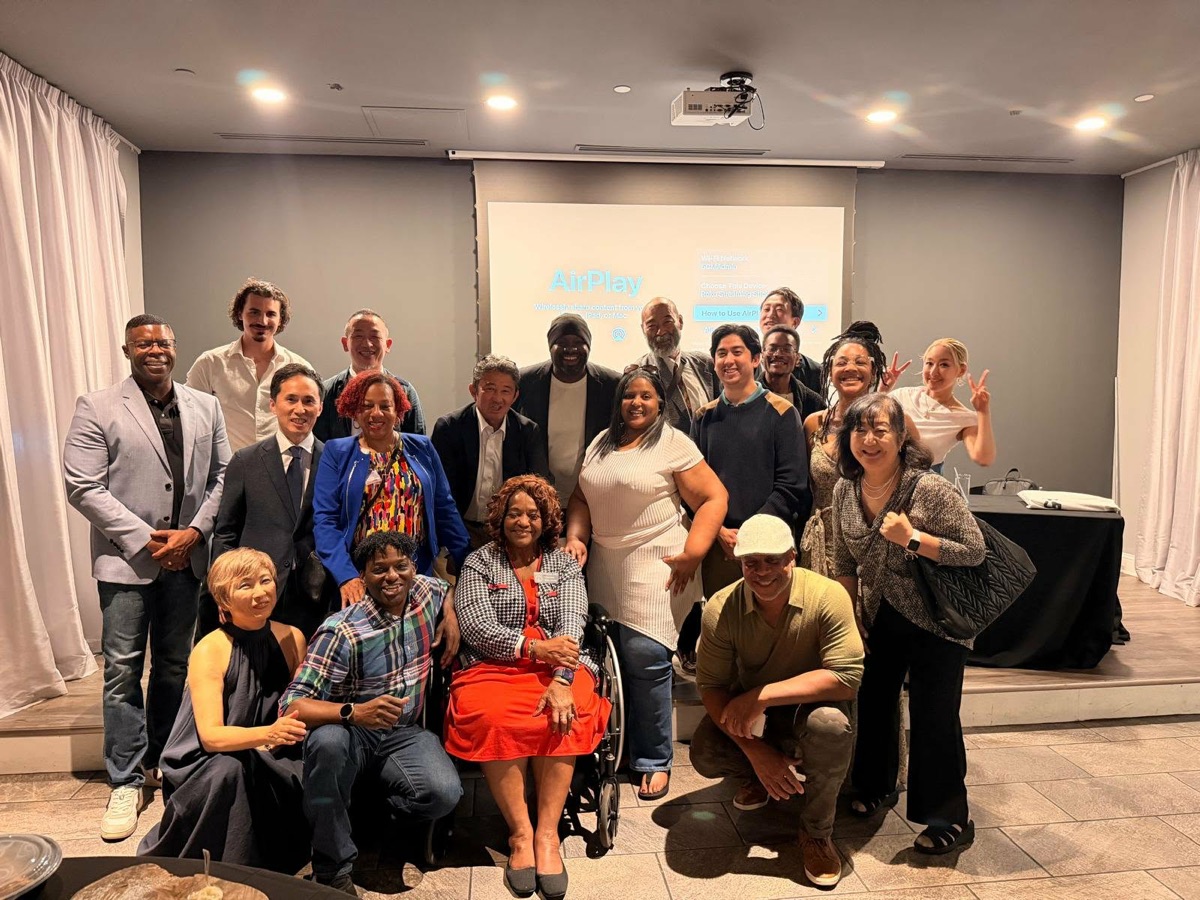 Guests from Georgia and Japan smiling together at a community evening in Georgia
